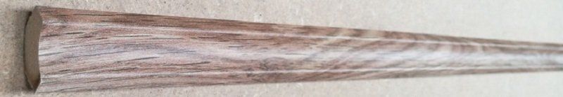 A piece of wood is sitting on top of a wooden table.