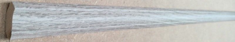 A piece of wood is sitting on top of a wooden table.