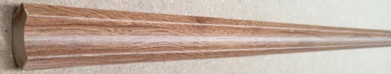 A wooden cone is sitting on top of a wooden table.