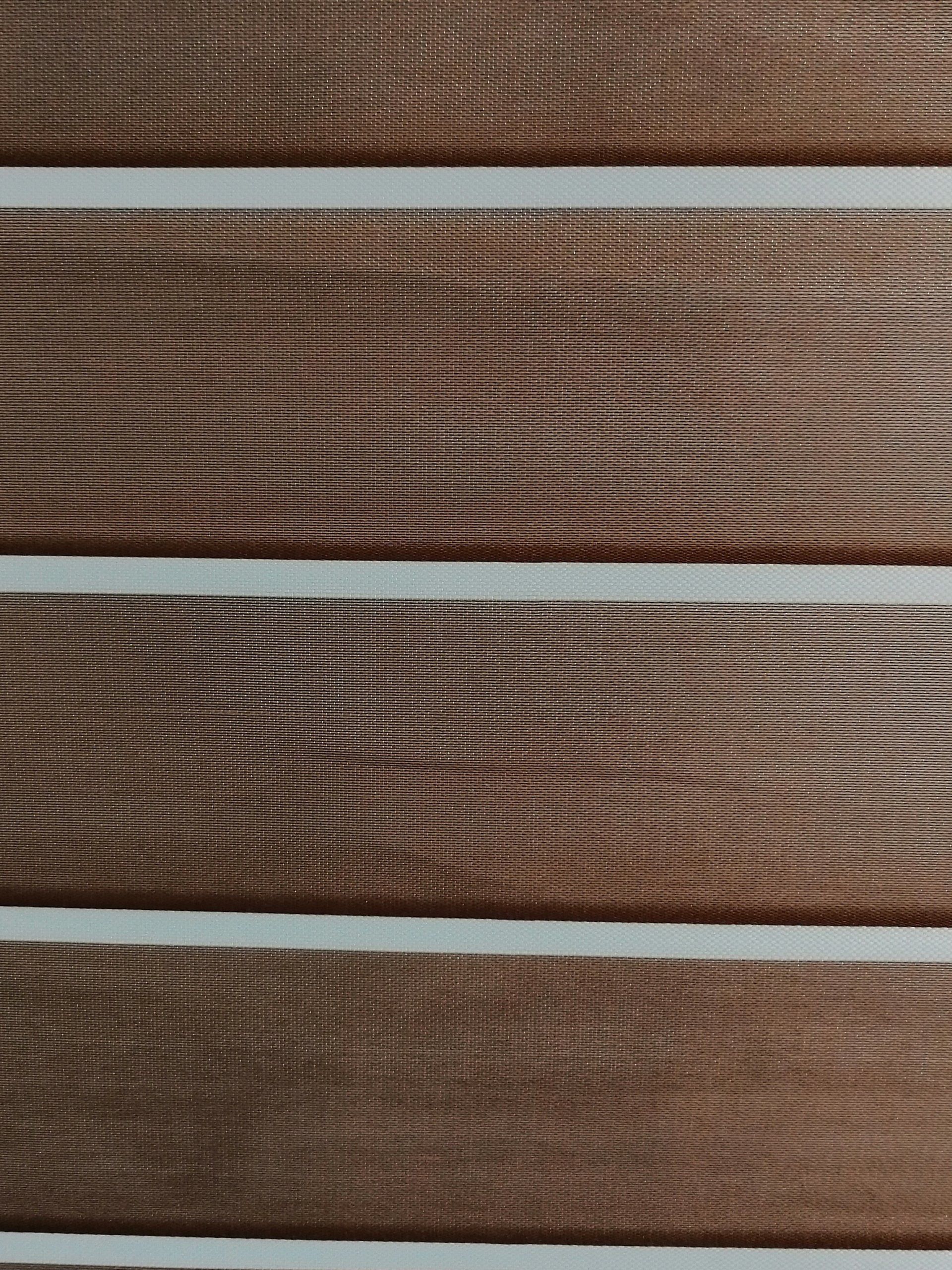 A close up of a wooden surface with white stripes on it.