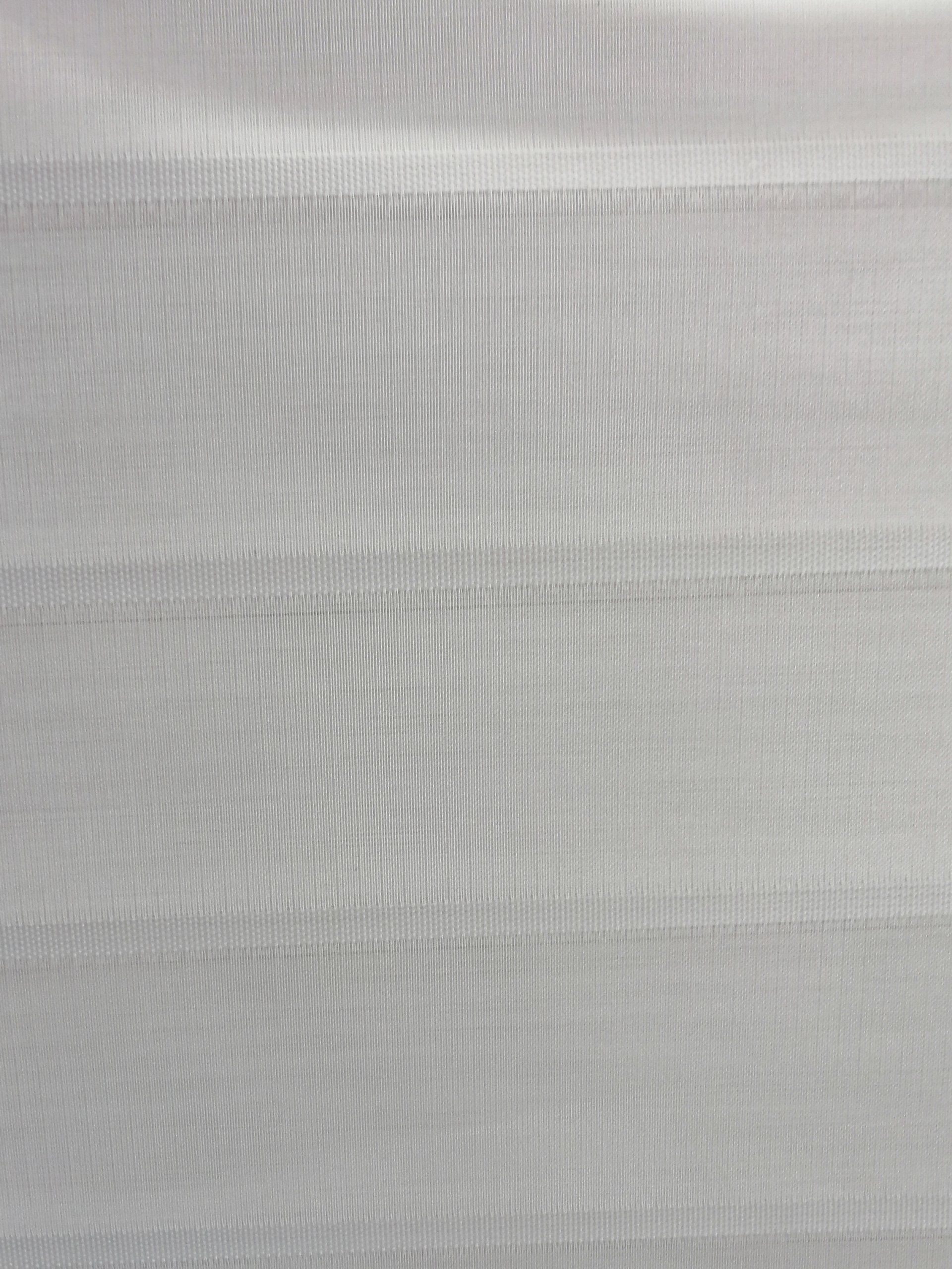 A close up of a white fabric with a striped pattern.