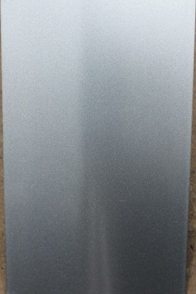 A close up of a metal surface with a gray gradient.