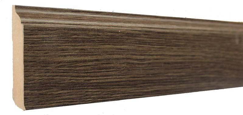 A close up of a wooden skirting board on a white background.