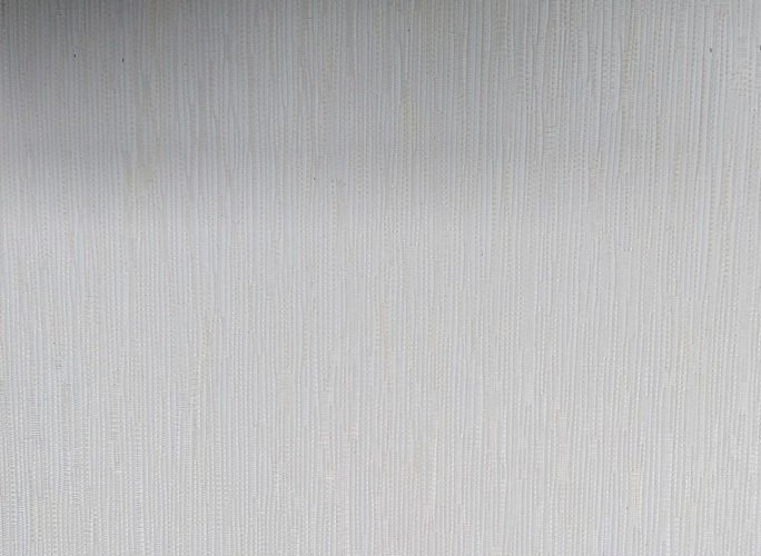 A close up of a stainless steel surface with a brushed finish.