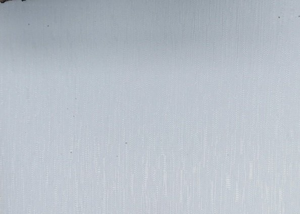 A close up of a white surface with a grainy texture.