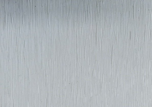 A close up of a stainless steel surface with a brushed finish.