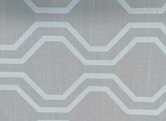 A close up of a white fabric with a geometric pattern on it.