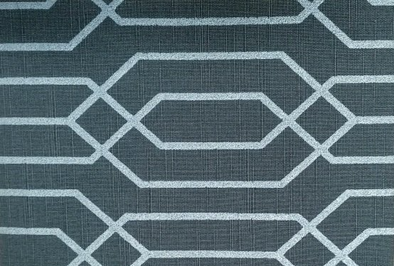A close up of a gray and white rug with a geometric pattern.