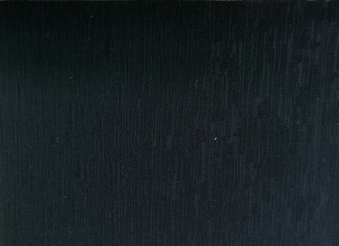 A close up of a black surface with a grainy texture.