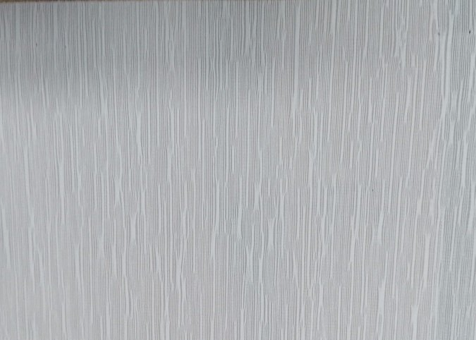 A close up of a white wall with a striped pattern.