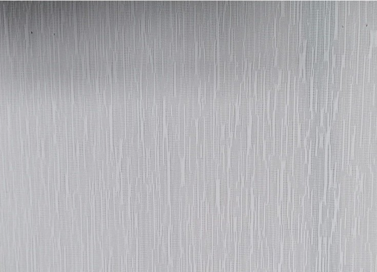 A close up of a stainless steel surface with a brushed finish.