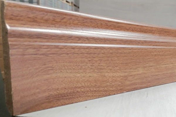 A piece of wood is sitting on top of a white surface.