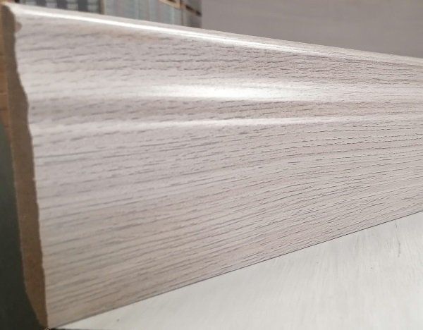 A white wooden skirting board is sitting on top of a white table.