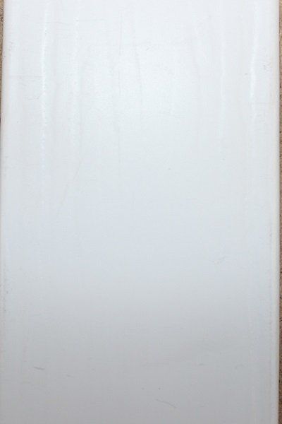 A white sheet of paper is sitting on a wooden table.