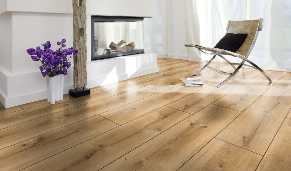 A living room with a wooden floor and a fireplace