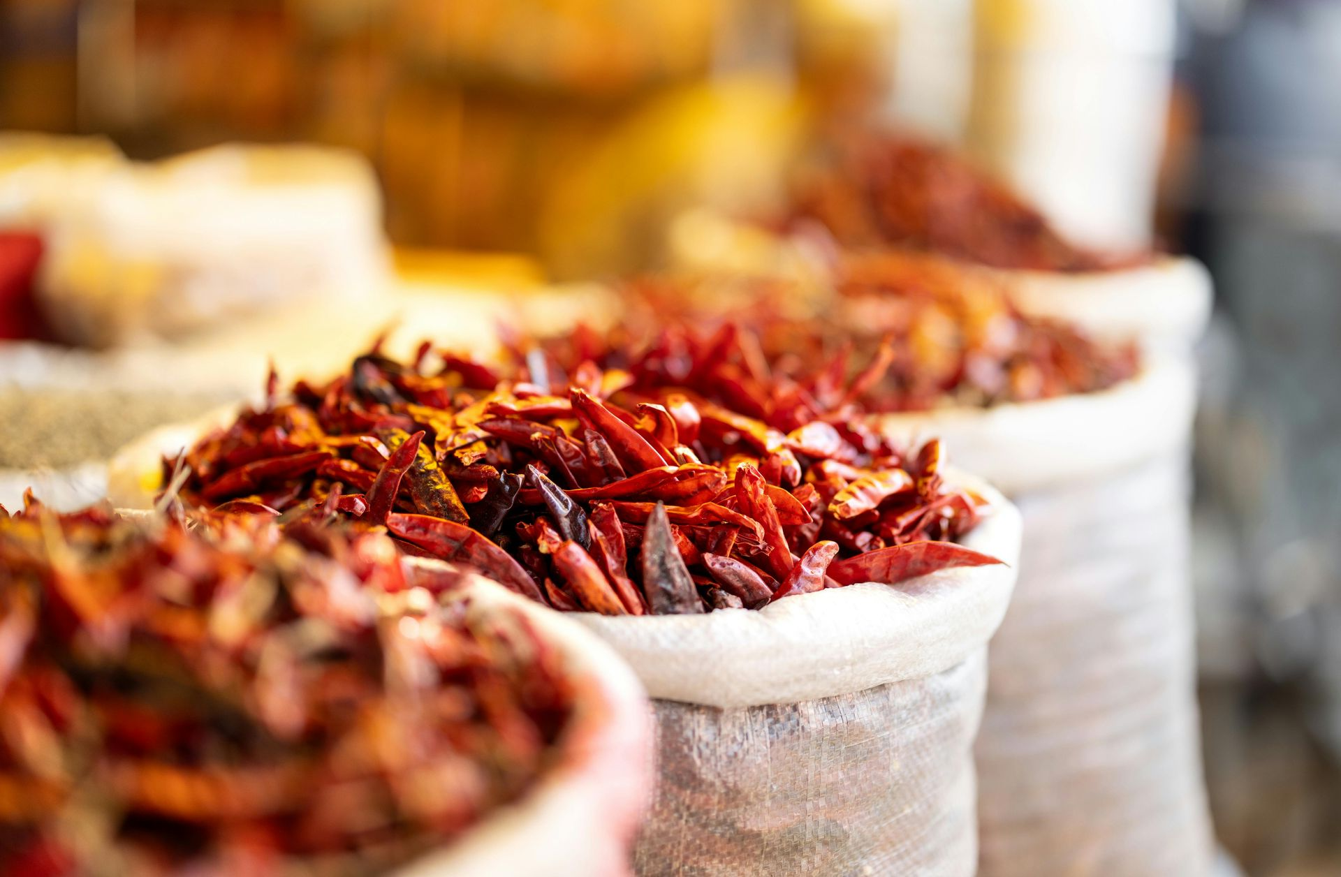 Bags of dried red chili peppers at a market.