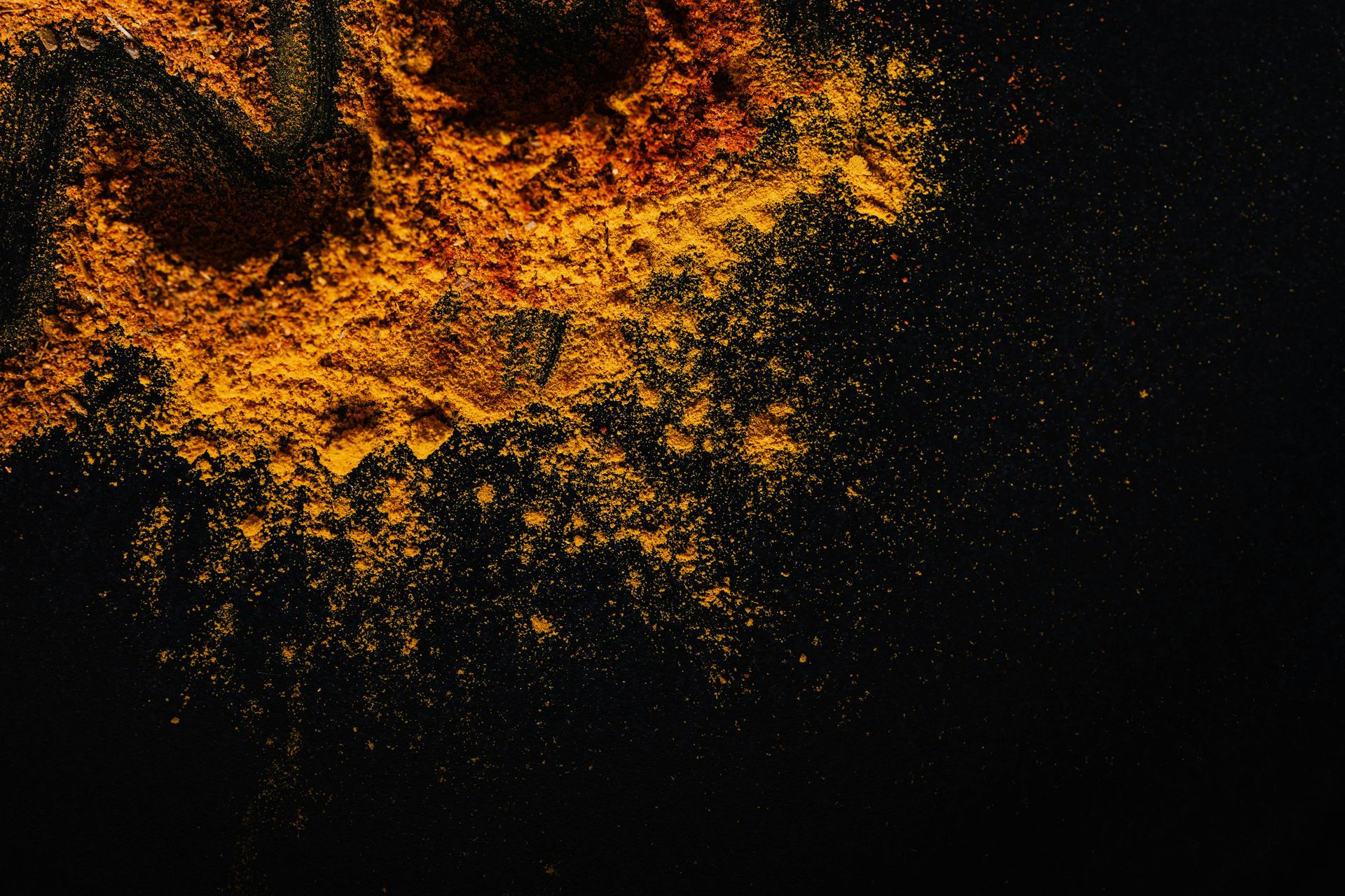 Yellow-orange powder scattered on a black background.