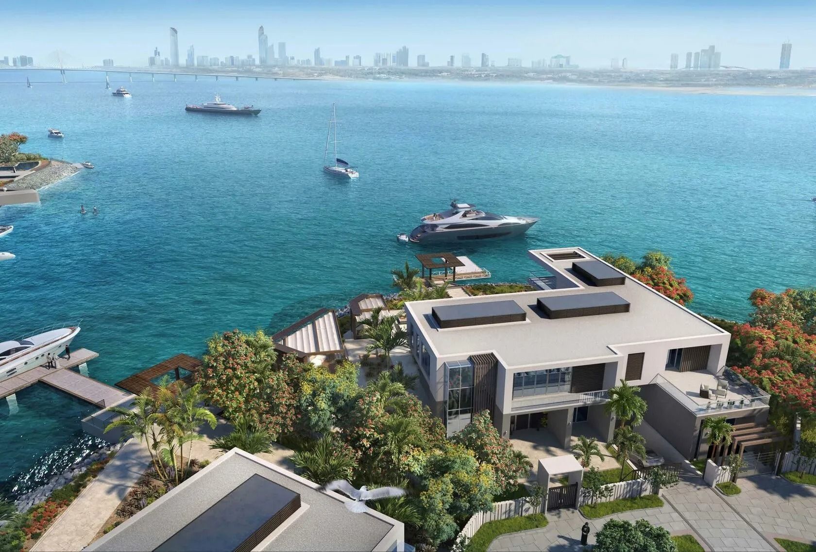 Modern waterfront villa with yachts in a turquoise bay, overlooking a city skyline.
