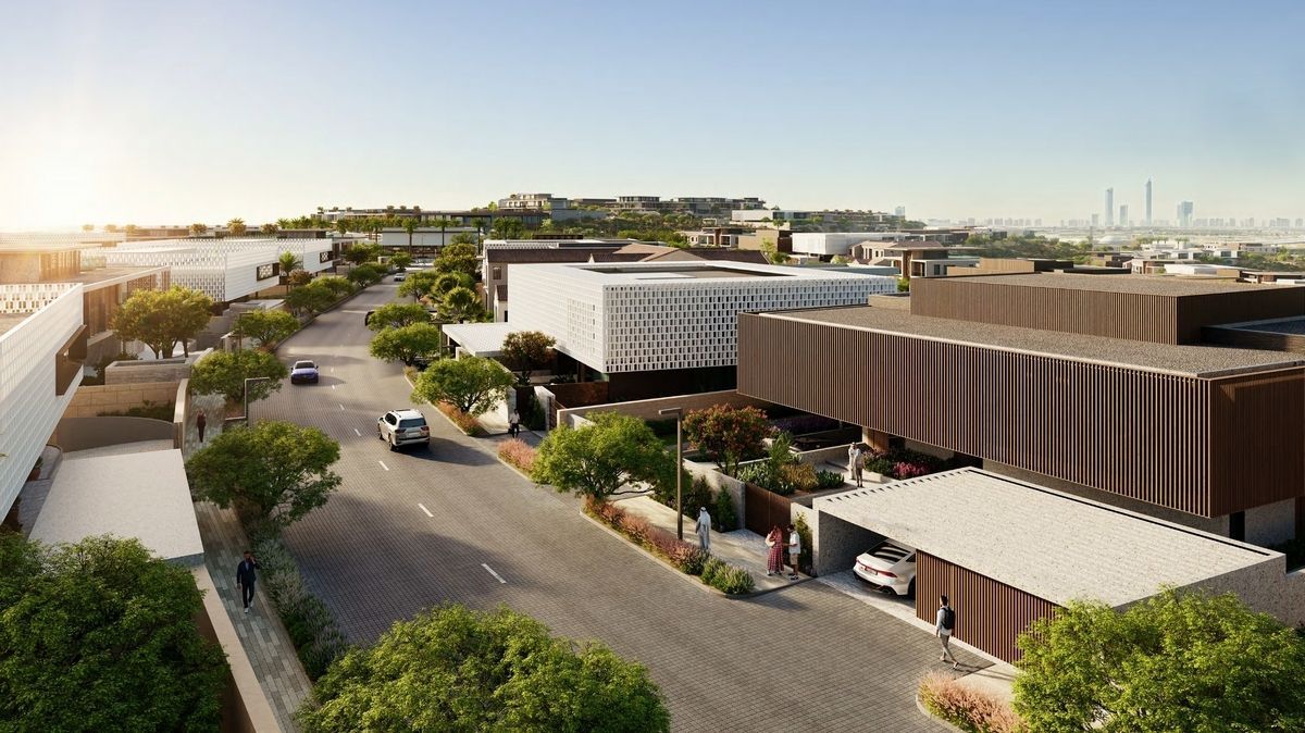 Street view of modern buildings, trees, and cars on a sunny day.