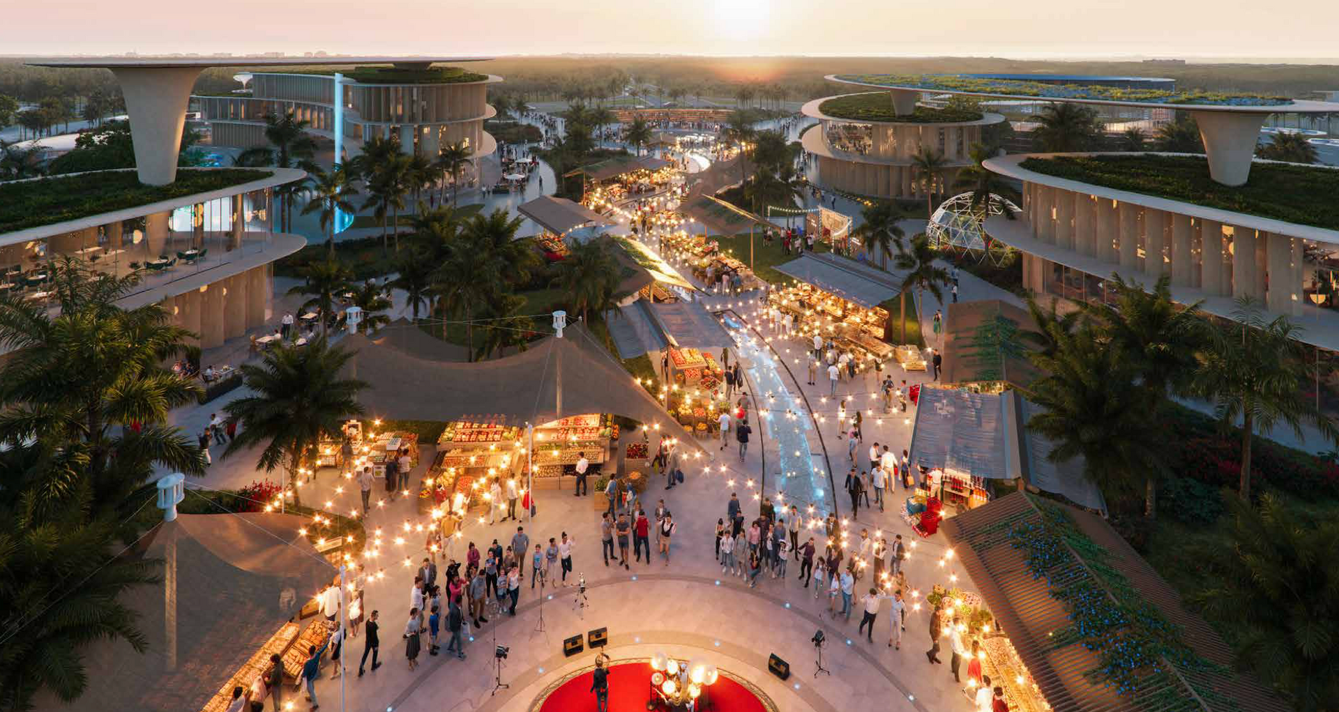 Aerial view of a festive outdoor market with crowds, string lights, and modern buildings at sunset.