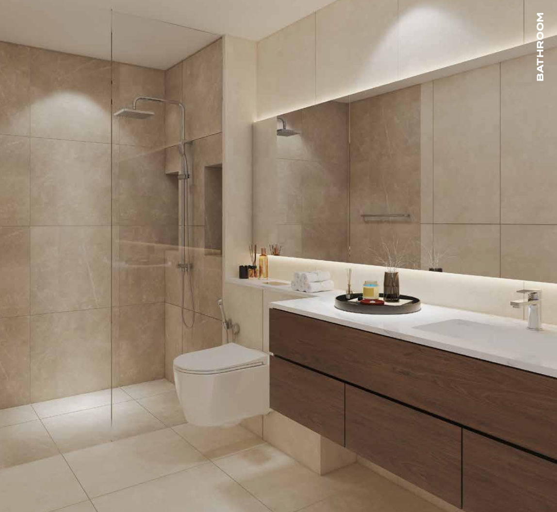 Modern bathroom with neutral-toned tiles, shower, toilet, wooden vanity, and large mirror with lighting.