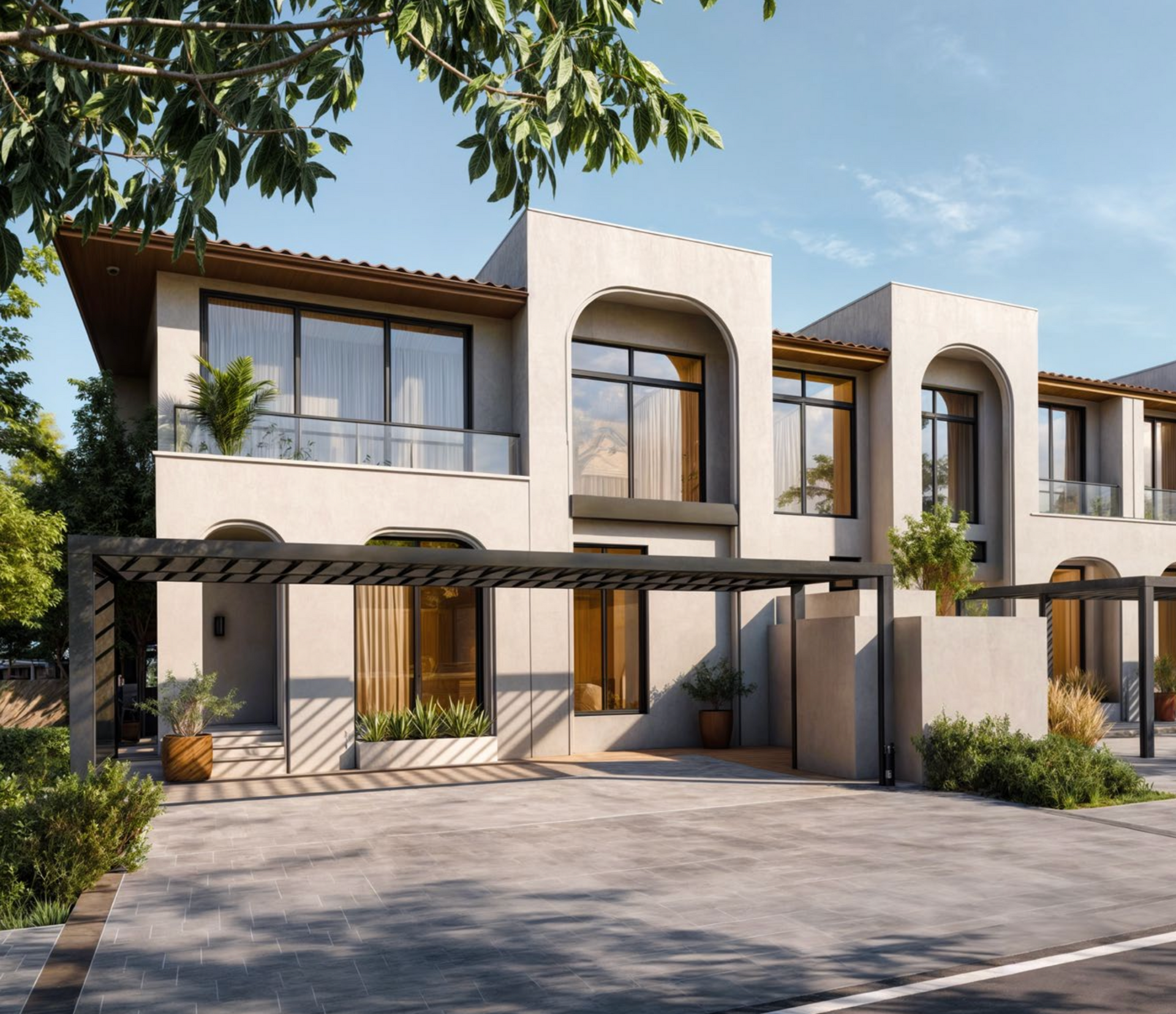 Modern townhouses with light stucco exterior, arched windows, and a carport.