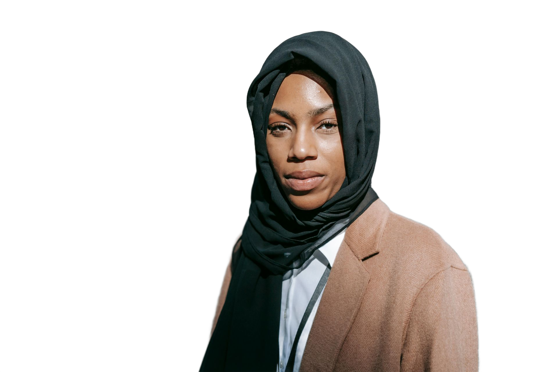 Person wearing a black hijab and a brown blazer, looking directly at the camera.