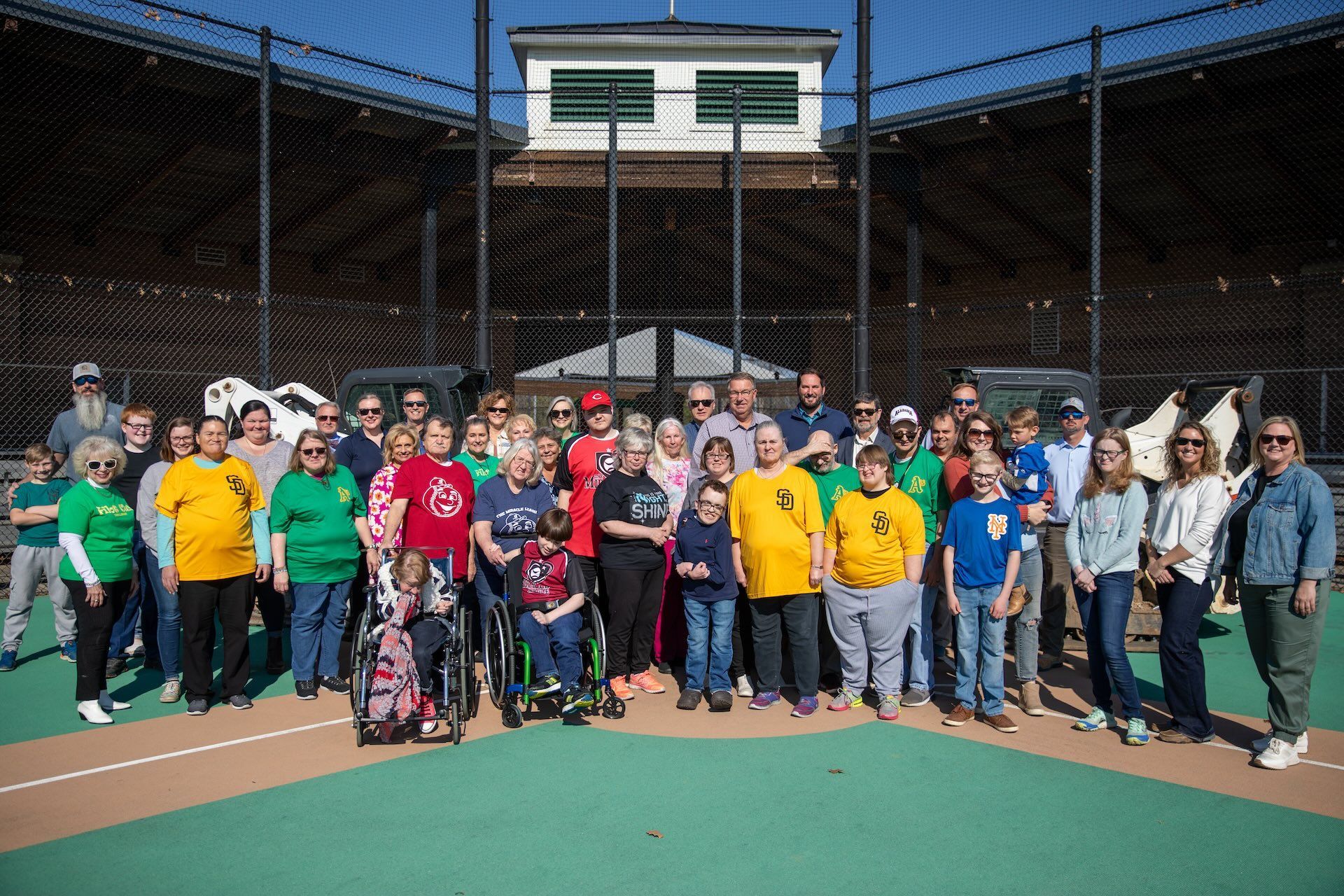 a large group of people are posing for a picture on the Field of Miracles in Cullman, AL