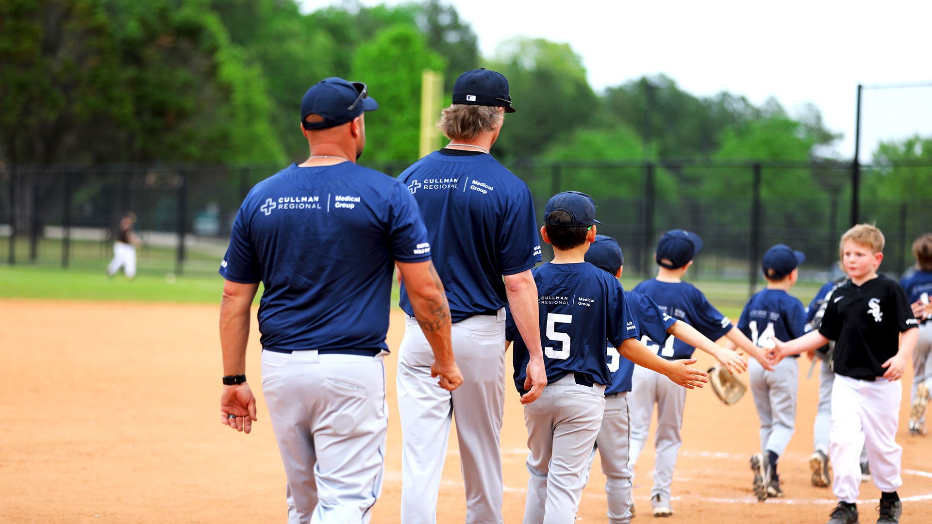 A group of baseball players are walking on a field.