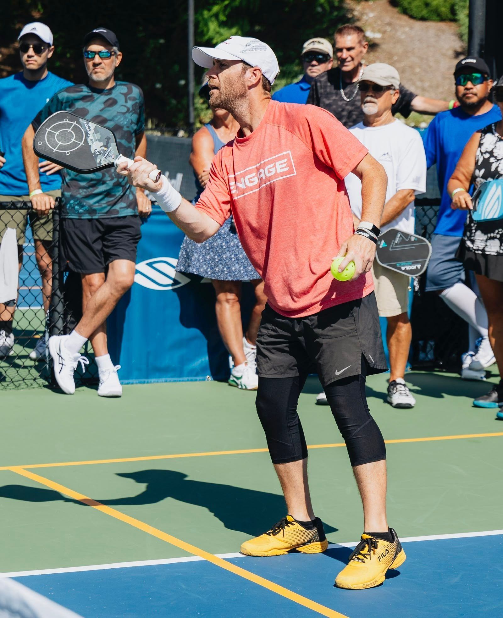 A man is playing paddle tennis on a tennis court
