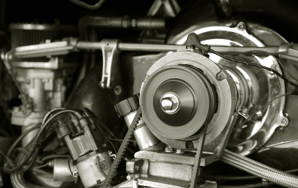 a close up of a car engine with a belt and pulley