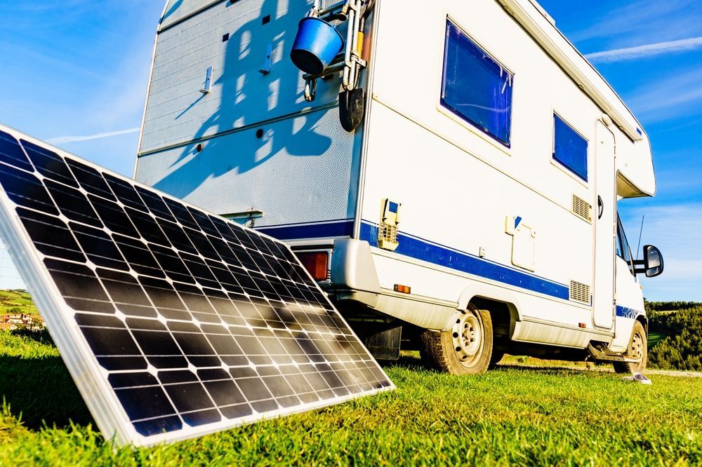 a rv with a solar panel attached to it