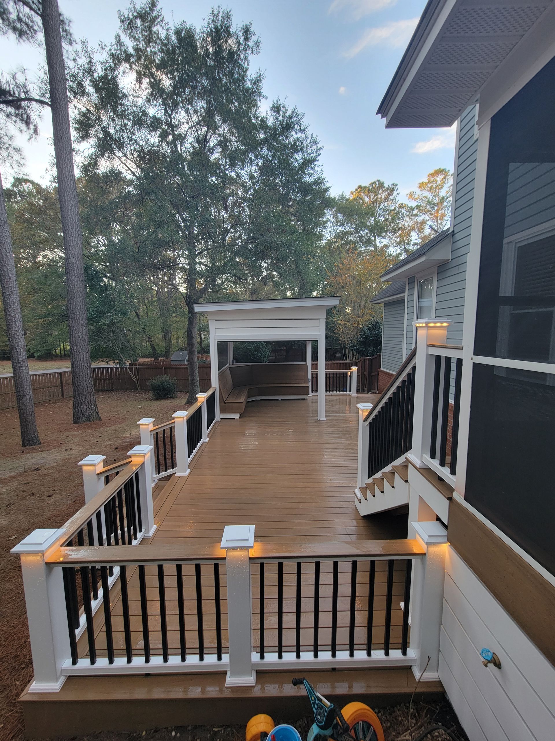 A house with a large deck and stairs leading to it