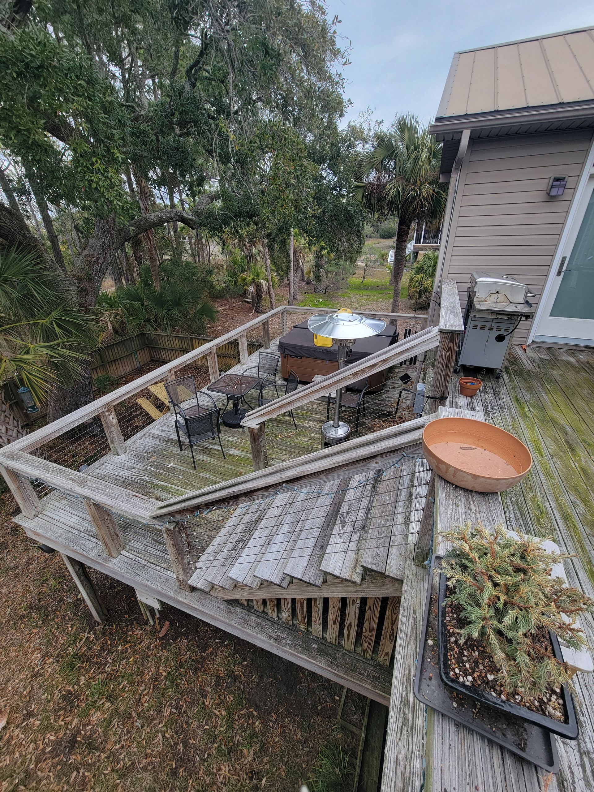 There is a hot tub on the deck of a house.