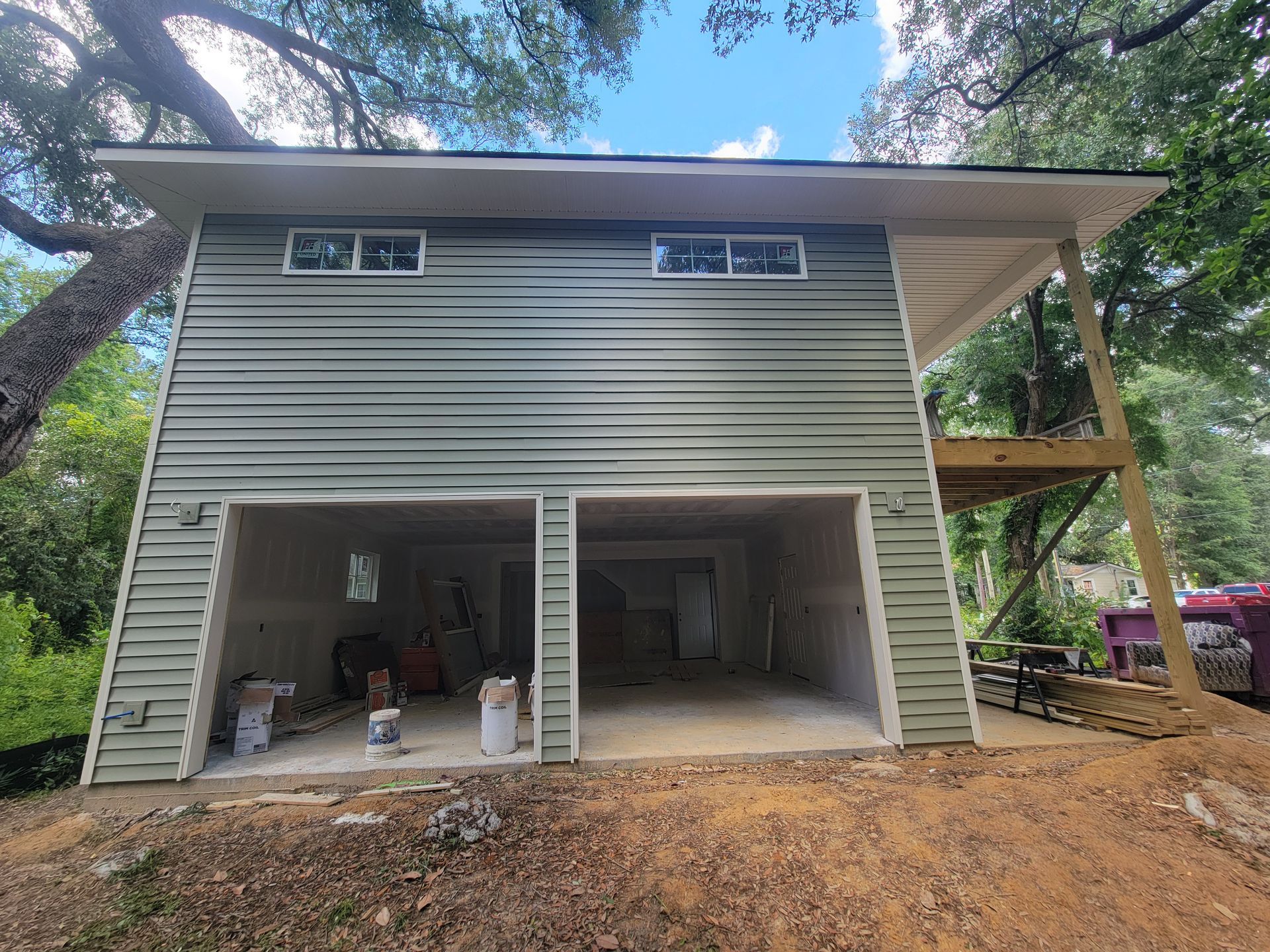 A house with a garage underneath it is being built.