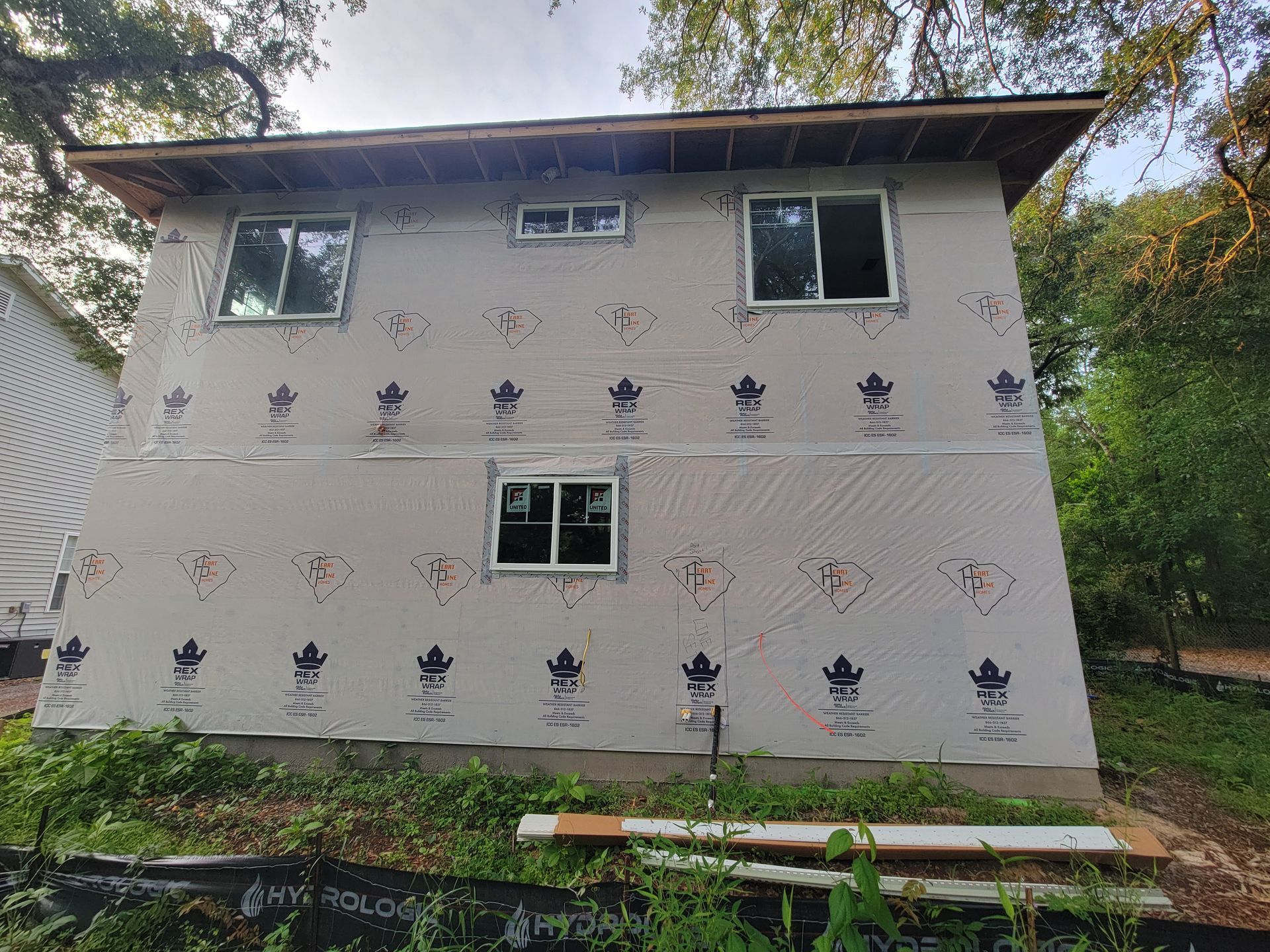 A house is being built with a lot of windows.