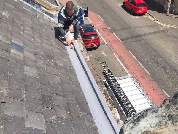 Roofers Kilmarnock fixing gutter brackets for new PVC guttering