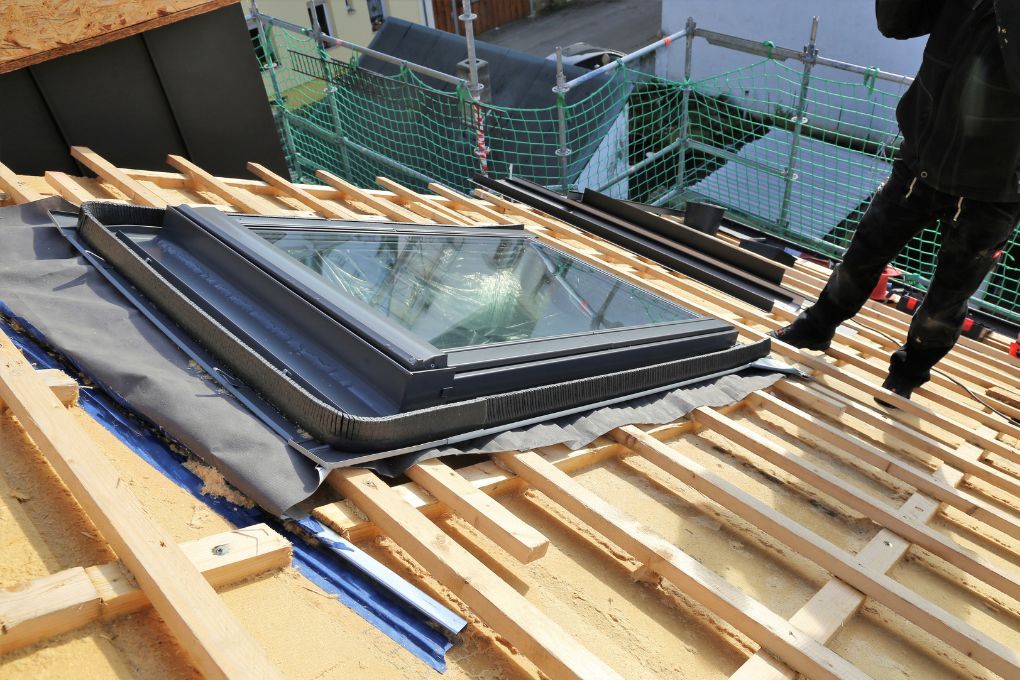 Roofers Kilmarnock installing a Velux skylight to a house