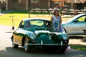 Woman standing next to classic car | Tedious Auto Repair