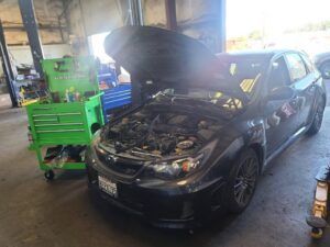 Vehicle with hood up in garage | Tedious Auto Repair