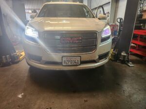 White GMC vehicle in garage | Tedious Auto Repair