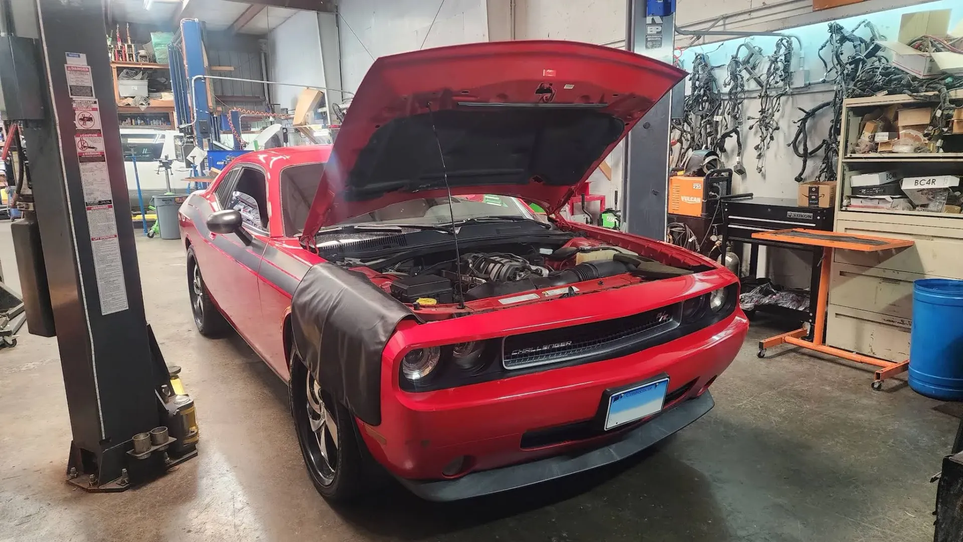 Red mustang with hood up in garage | Tedious Auto Repair