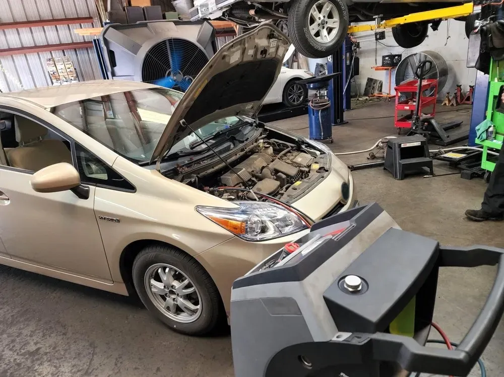 Tan can with hood up in garage | Tedious Auto Repair