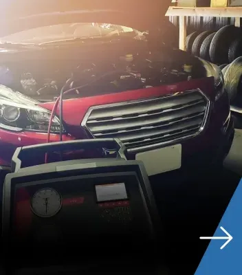 Red vehicle with hood up in the progress of receiving AC Services repair | Tedious Auto Repair