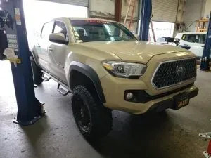 Cream-colored truck parked in garage | Tedious Auto Repair