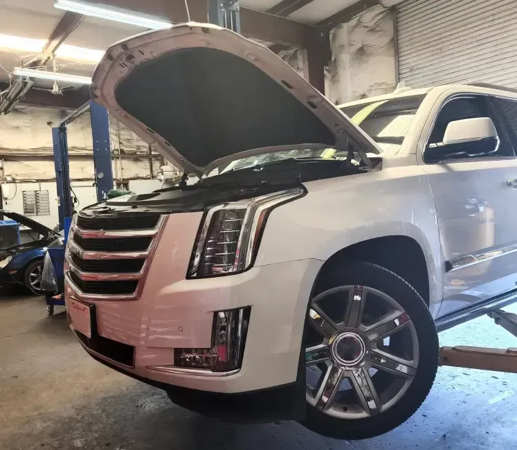 White SUV with hood up in garage | Tedious Auto Repair