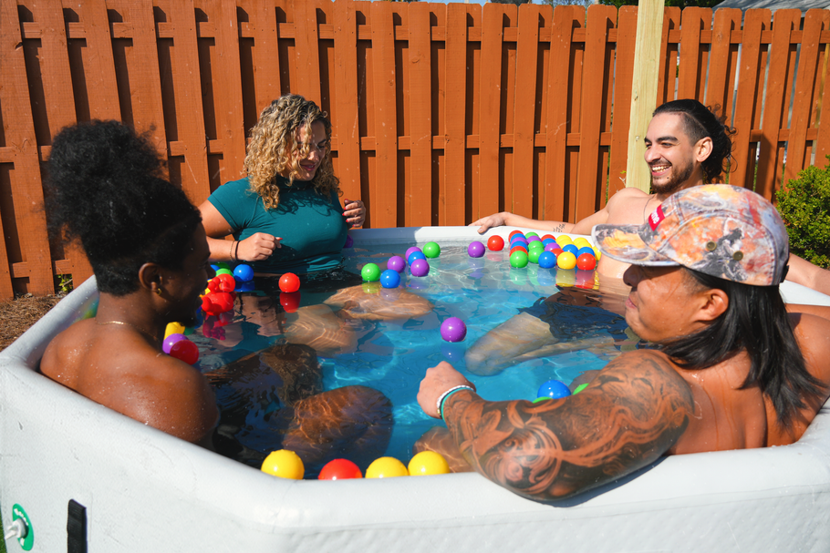 Group of people smiling in a cold plunge tub