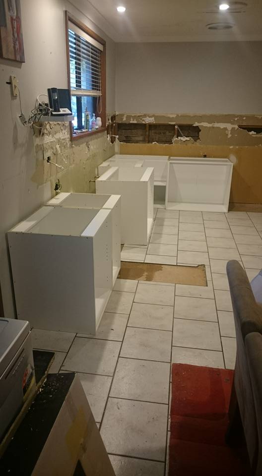 kitchen cabinets being installed