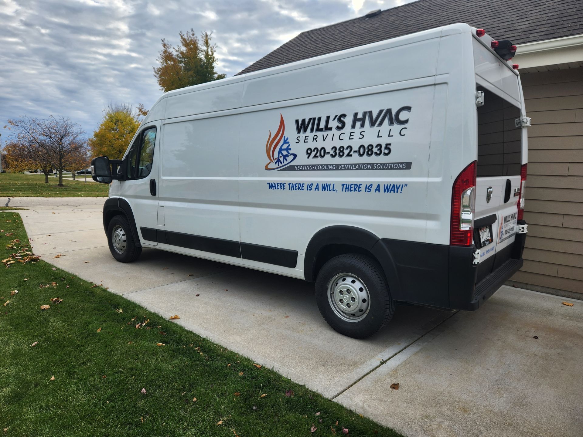 White HVAC service van parked in a driveway. Logo says Will's HVAC Services LLC and a phone number.