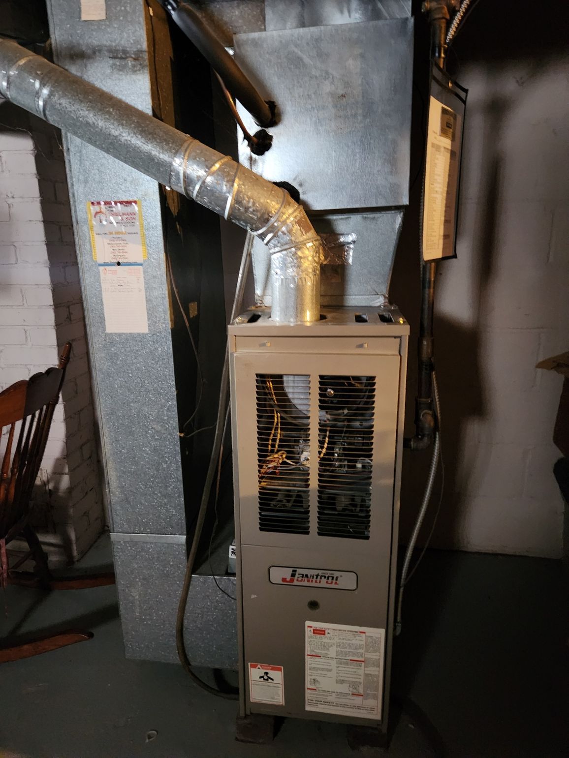 Gas furnace with ductwork in a basement.